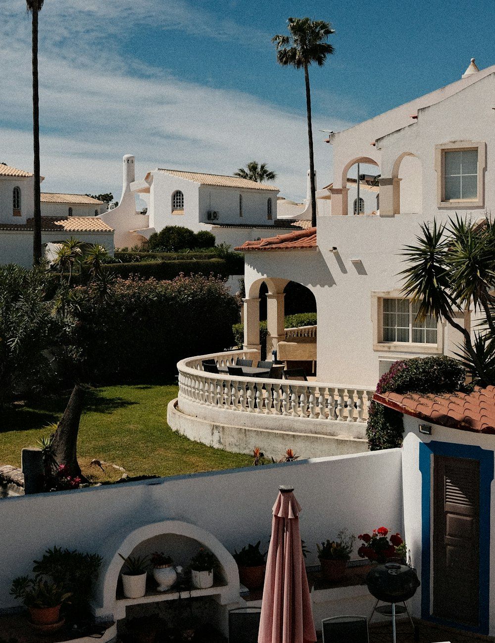 Whitewashed holiday villas with palms above a terrace